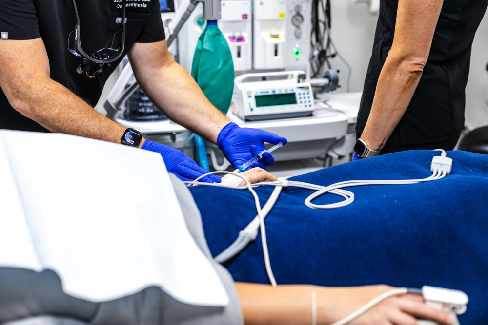 Dental anesthesia team placing an IV line for sedation