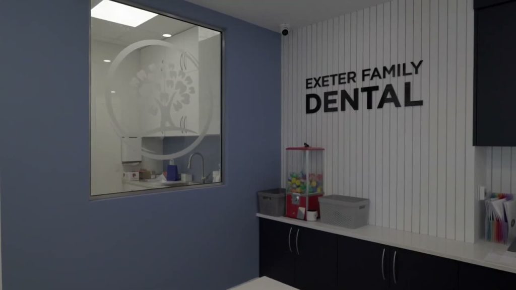 Exeter Family Dental sign on the wall beside the front counter
